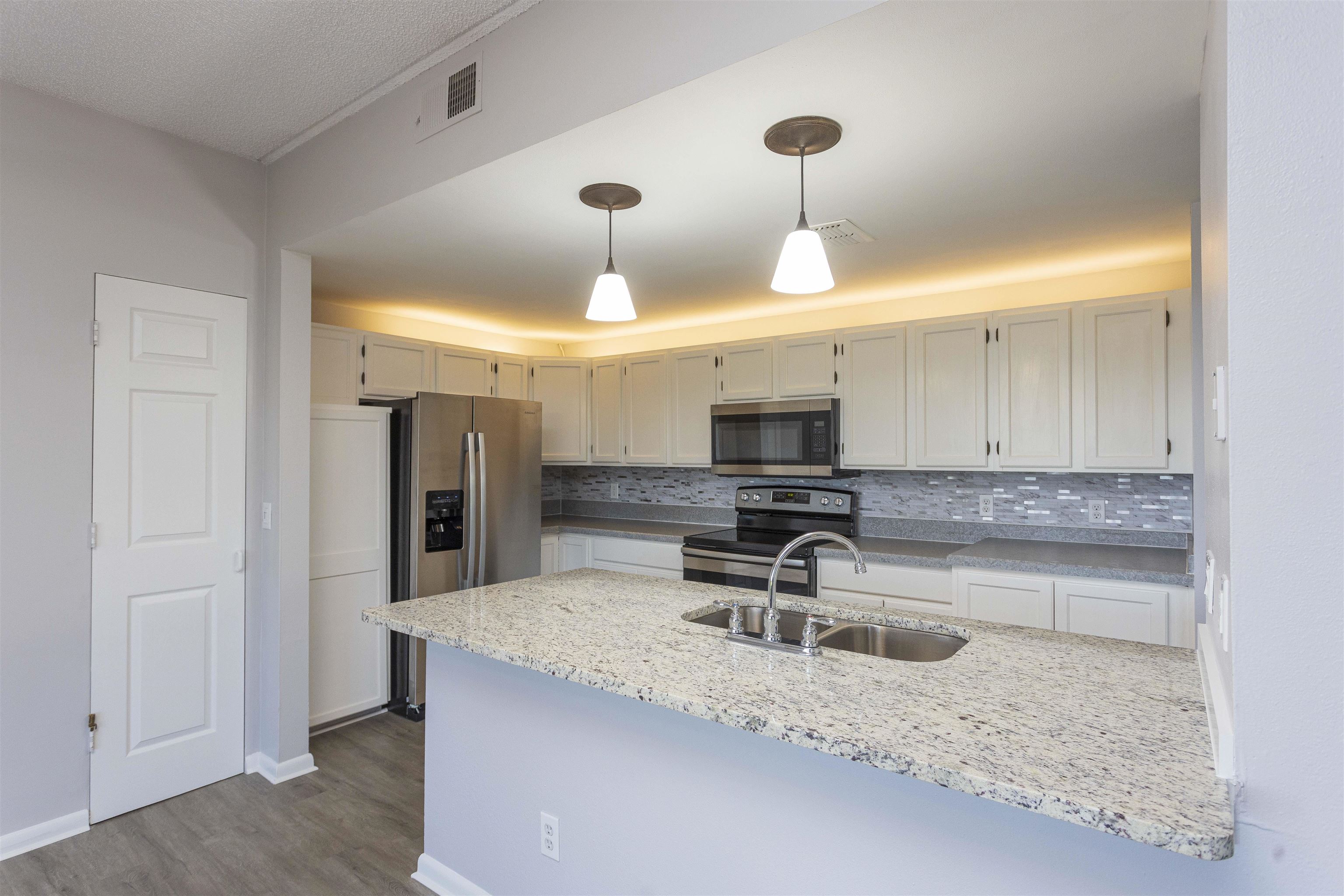 9 Aledo Court St. Augustine, FL 32086 - Photo 30 of 33 a kitchen with granite countertop a sink stainless steel appliances and cabinets
