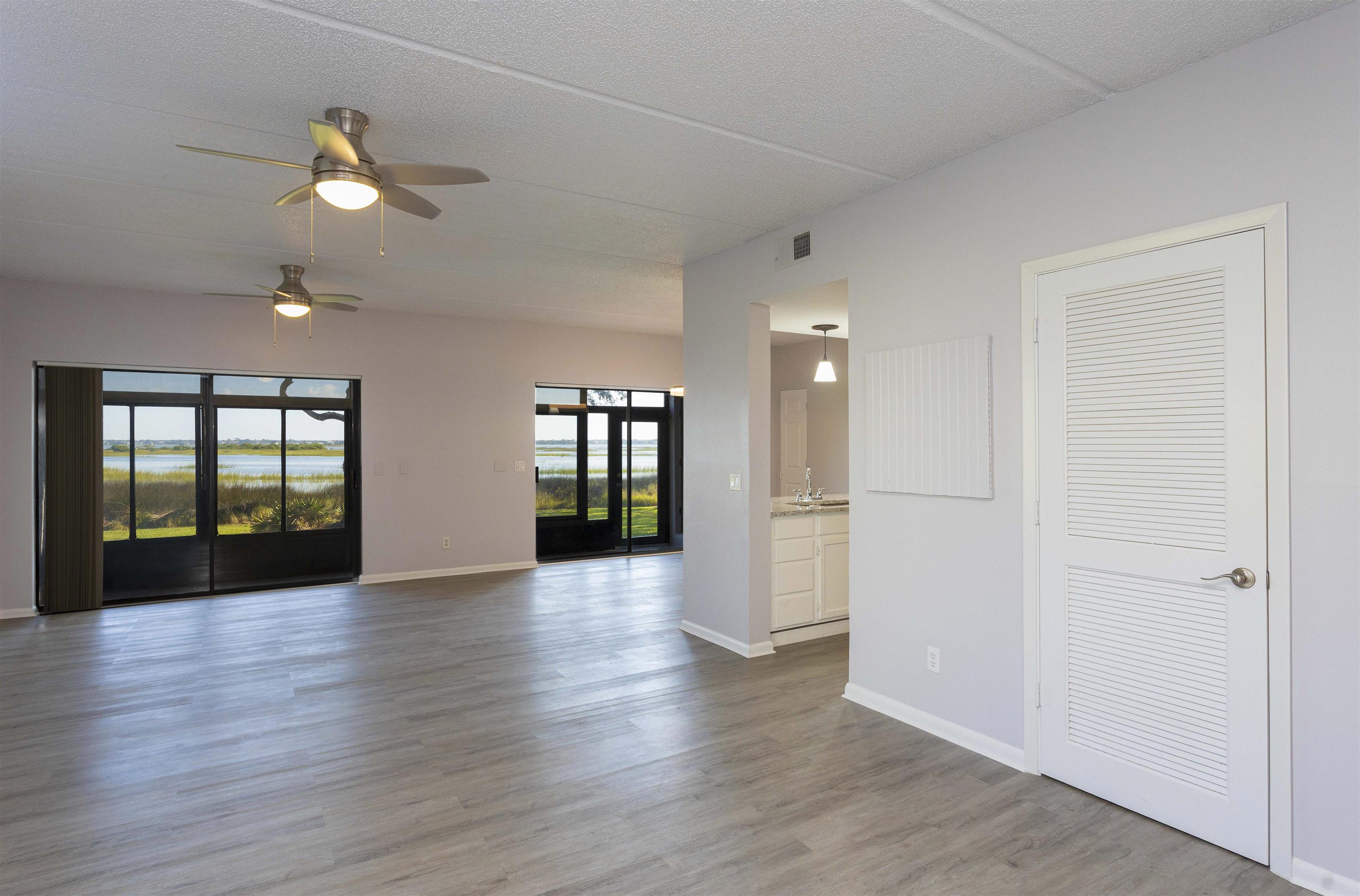 9 Aledo Court St. Augustine, FL 32086 - Photo 3 of 33 a view of an empty room with wooden floor and a window