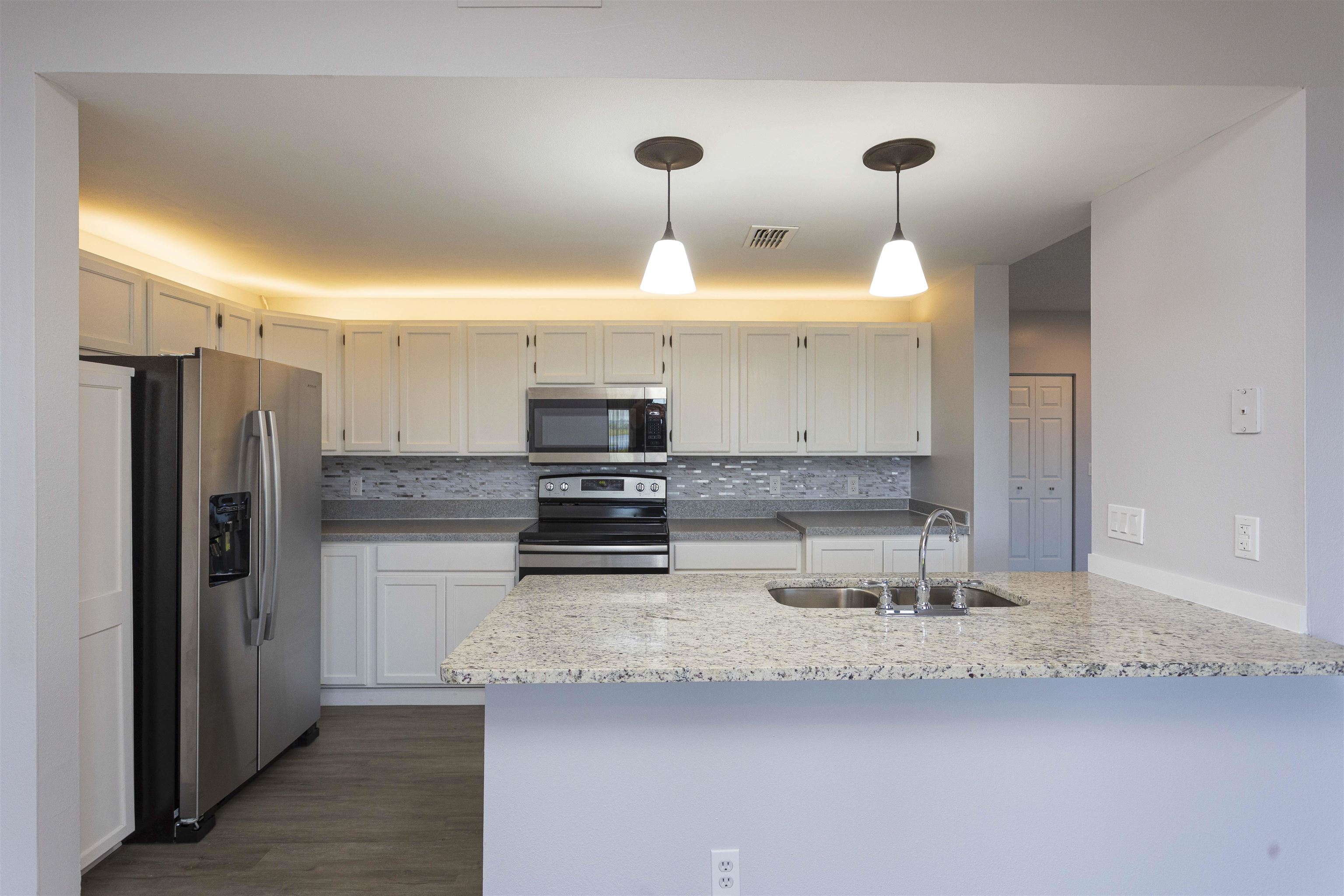 9 Aledo Court St. Augustine, FL 32086 - Photo 31 of 33 a kitchen with stainless steel appliances a sink a refrigerator and a counter space