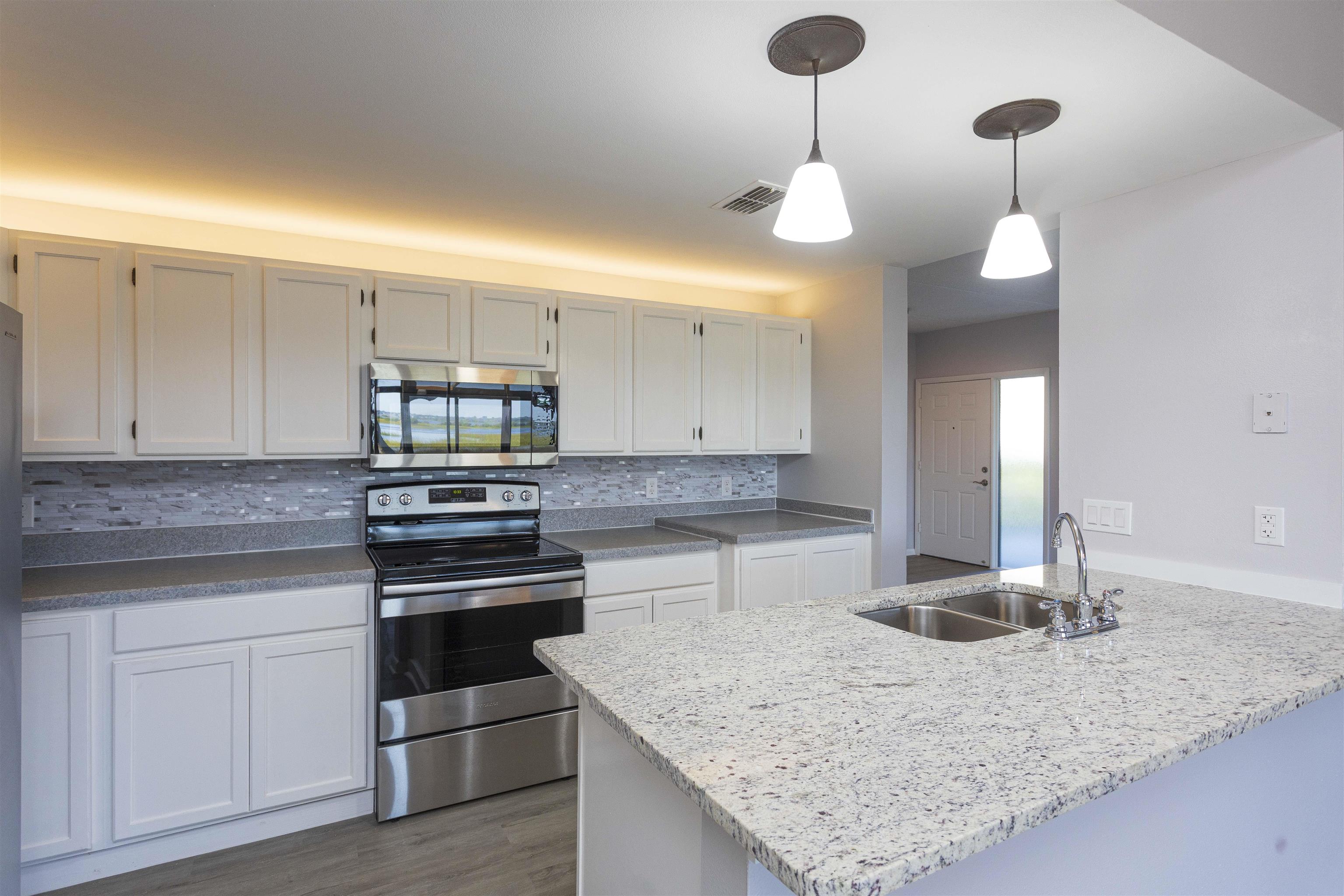 9 Aledo Court St. Augustine, FL 32086 - Photo 32 of 33 a kitchen with stainless steel appliances granite countertop a sink a stove and cabinets