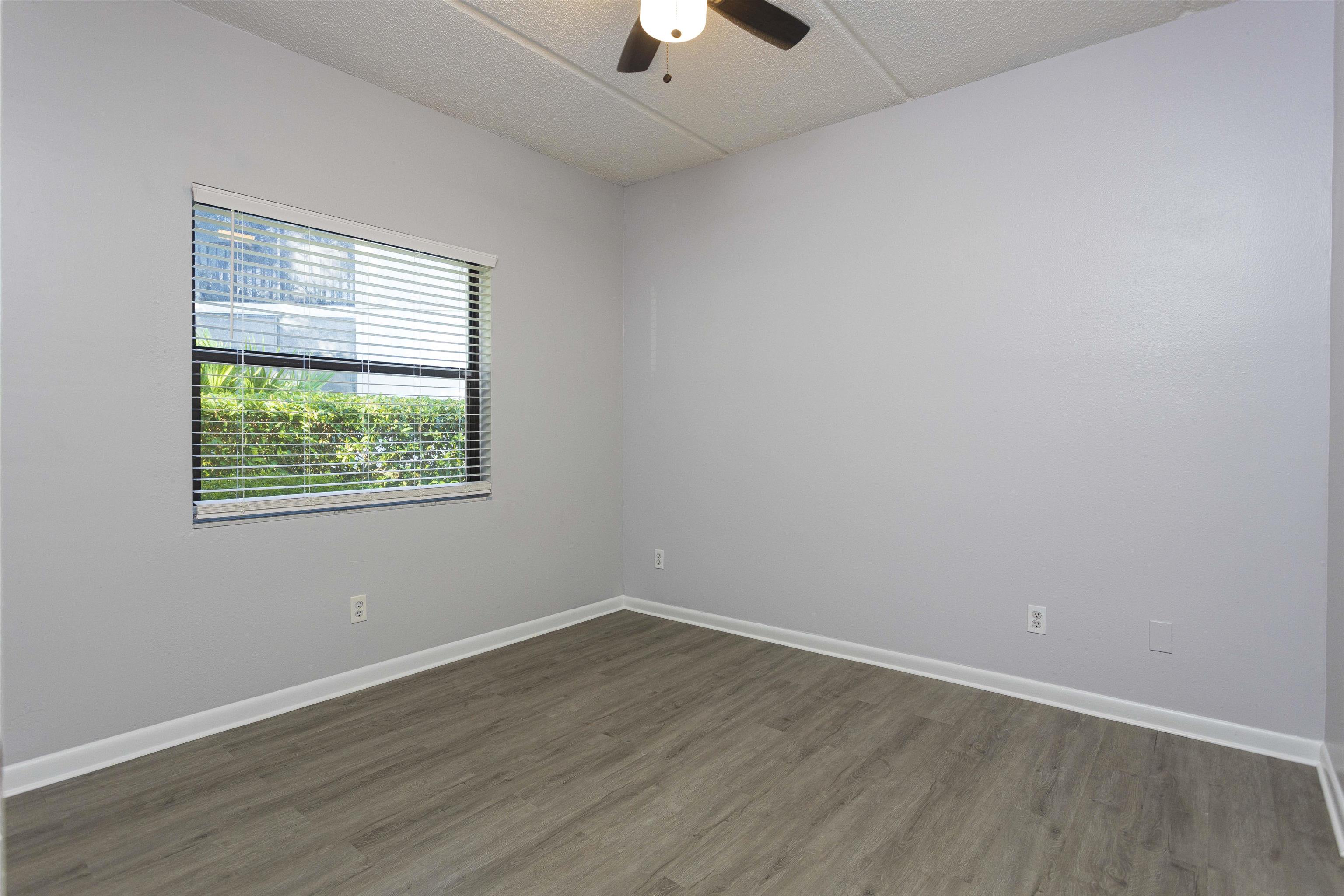 9 Aledo Court St. Augustine, FL 32086 - Photo 4 of 33 wooden floor in an empty room with a window