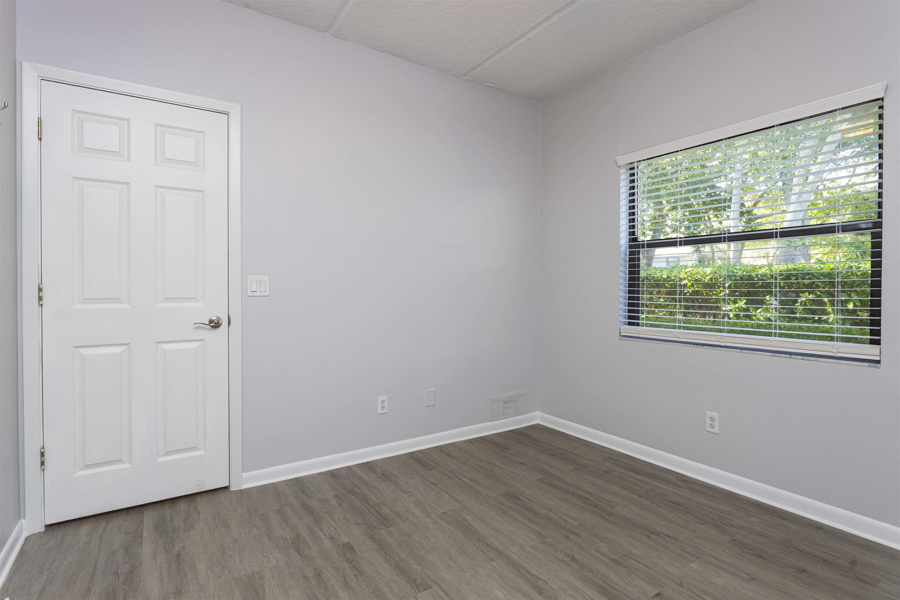 9 Aledo Court St. Augustine, FL 32086 - Photo 5 of 33 a view of an empty room with wooden floor and a window