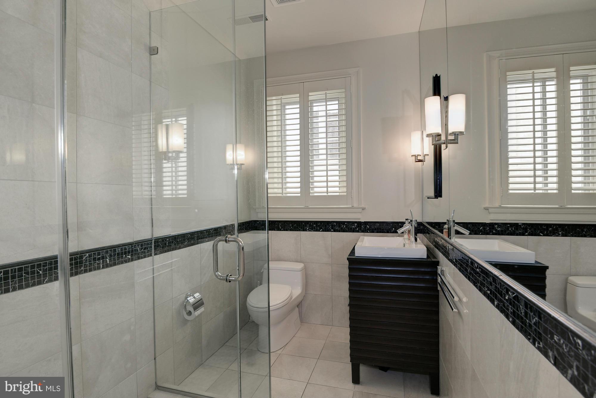 2441 California Street Northwest Washington, DC 20008 - Photo 15 of 22 a bathroom with a granite countertop sink a toilet and shower