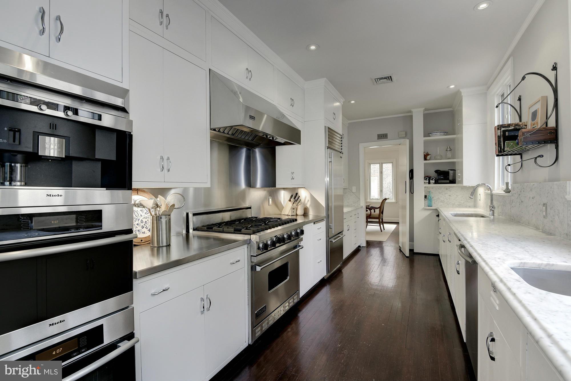 2441 California Street Northwest Washington, DC 20008 - Photo 8 of 22 a kitchen with stainless steel appliances a stove sink and cabinets