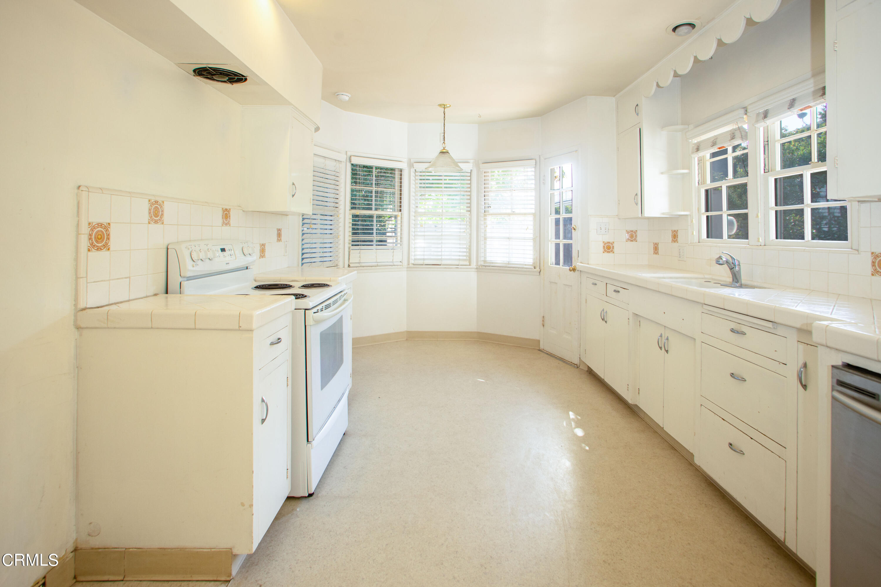 2971 Foothill Road Ventura, CA 93003 - Photo 7 of 25 a kitchen with white cabinets and white appliances