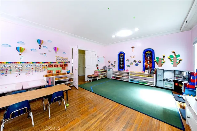 a living room with furniture and a dining table with kitchen view
