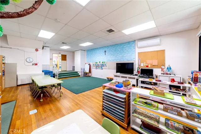 a living room with furniture a flat screen tv and a table
