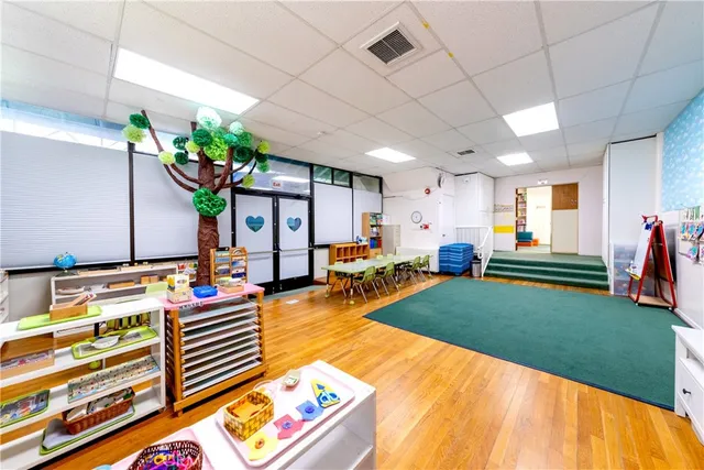 a view of a livingroom with wooden floor and cabinet