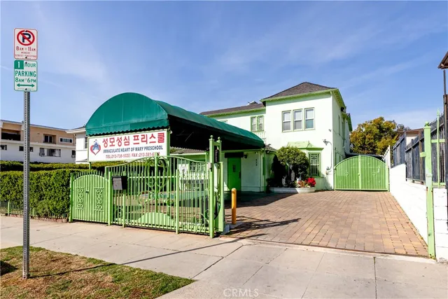 a view of a house with a porch and potted plants