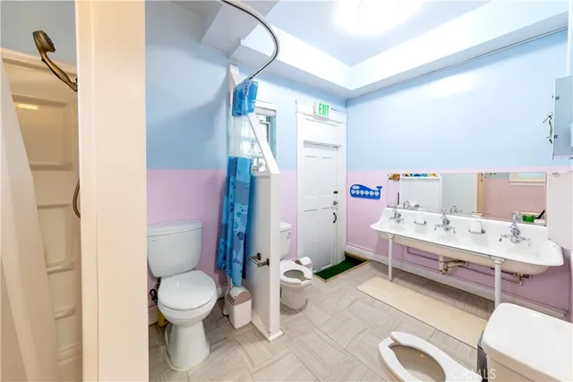 a view of a bedroom with baby crib and deck