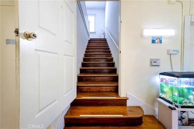 a bathroom with a granite countertop sink mirror vanity and toilet