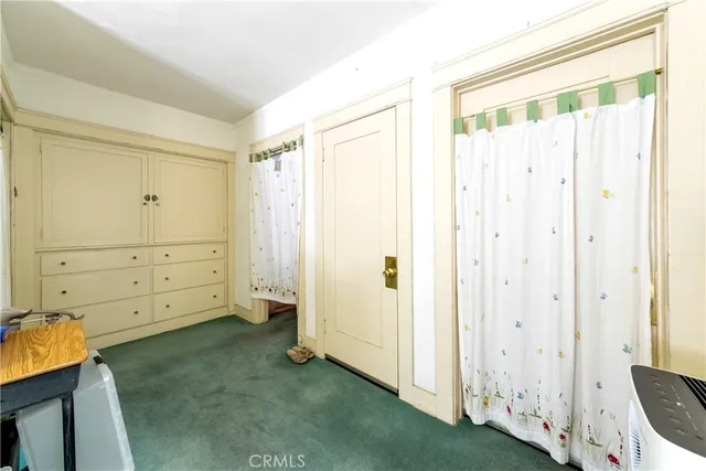 a room with furniture and a kitchen view