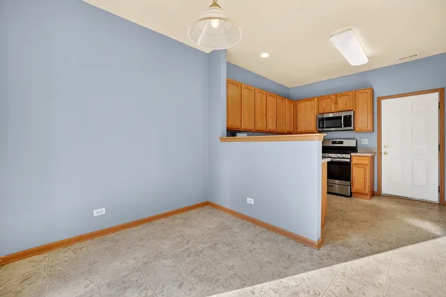 a bathroom with a bathtub and a chandelier