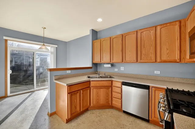 a kitchen with stainless steel appliances a refrigerator sink and cabinets