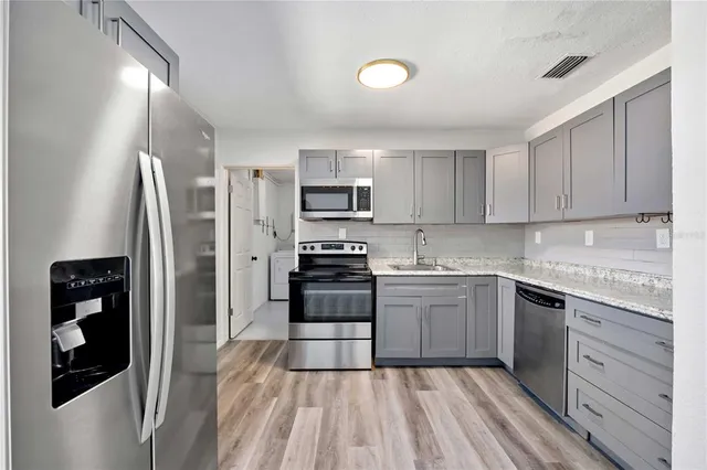 a kitchen with a refrigerator stove and sink