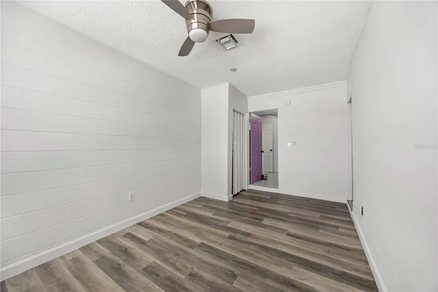 a view of a room with wooden floor
