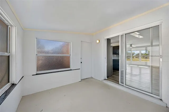 an empty room with a bathroom and a mirror