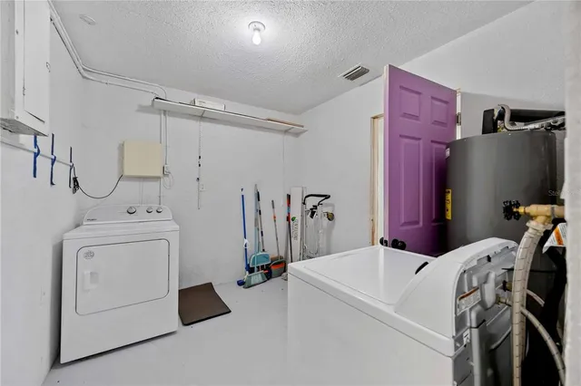 a view of a storage & utility room with dryer and washer