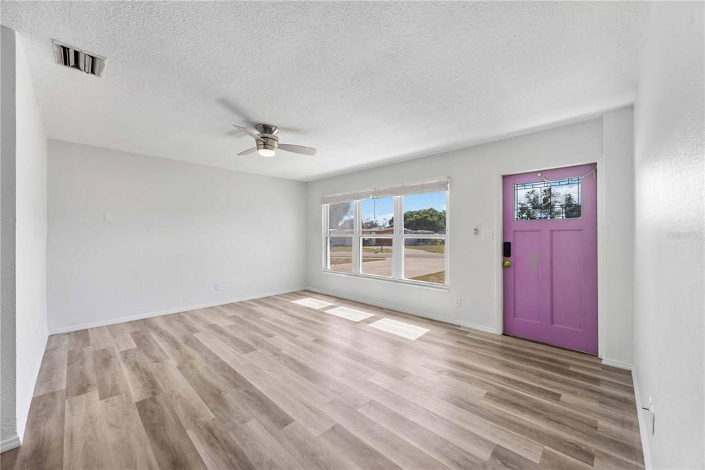 6319 Lafayette Road Bradenton, FL 34207 - Photo 5 of 30 a view of a livingroom with wooden floor and a ceiling fan