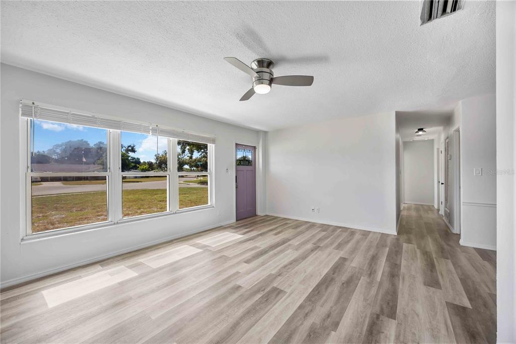 6319 Lafayette Road Bradenton, FL 34207 - Photo 9 of 30 a view of an empty room with a window and wooden floor