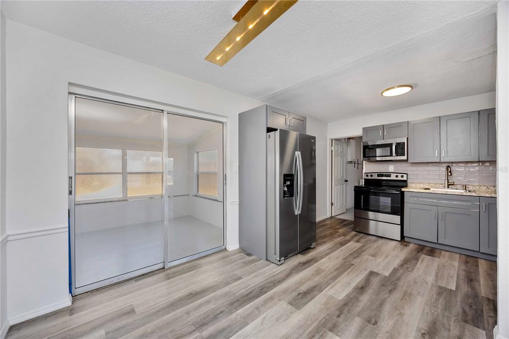 6319 Lafayette Road Bradenton, FL 34207 - Photo 10 of 30 a kitchen with granite countertop a refrigerator and a stove top oven