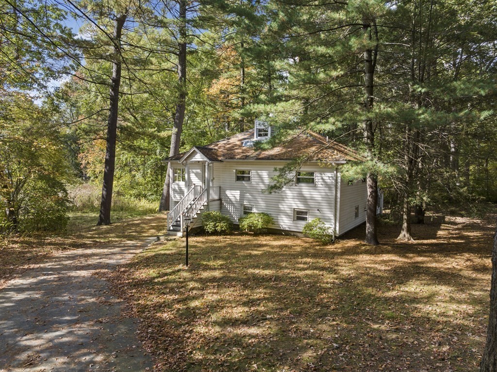 44 None Such Way Weston, MA 02493 - Photo 2 of 11 a bench is sitting in middle of a yard