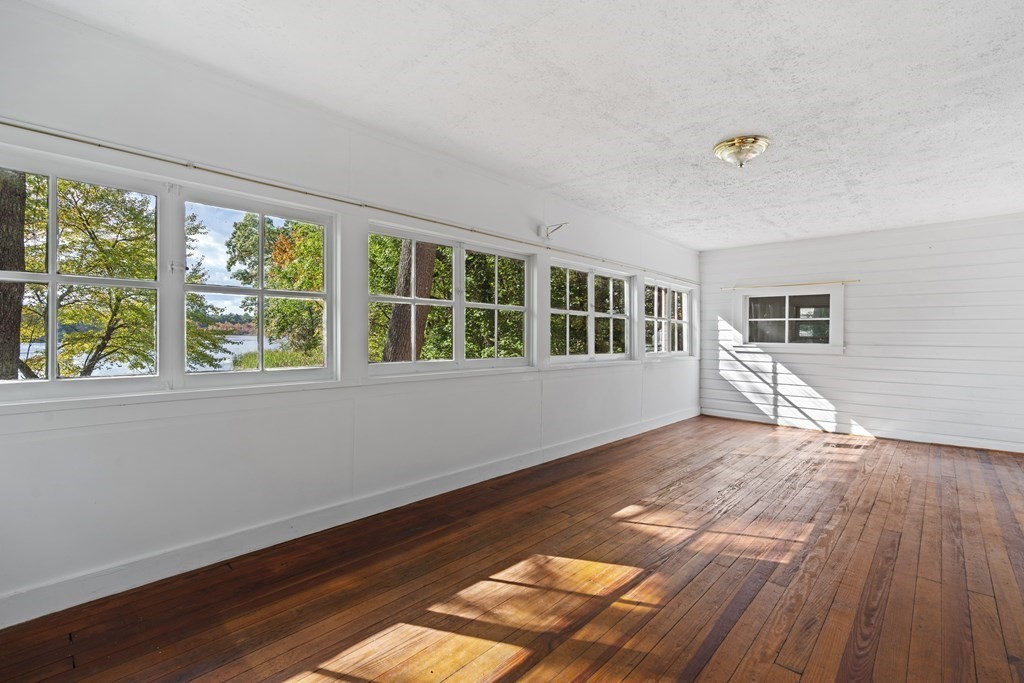 44 None Such Way Weston, MA 02493 - Photo 3 of 11 a view of empty room with wooden floor and fan