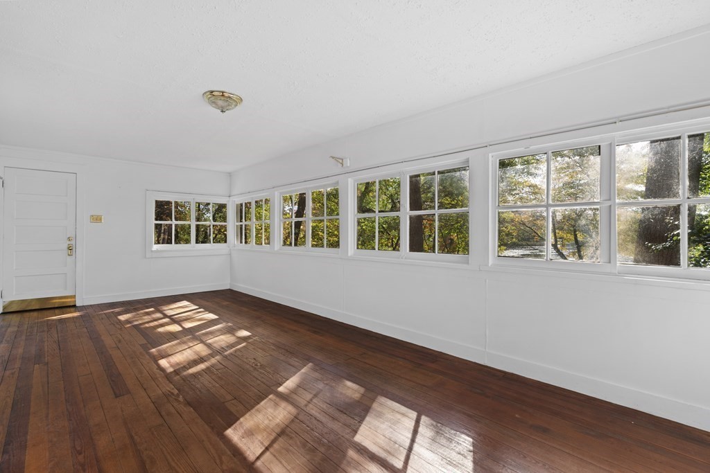 44 None Such Way Weston, MA 02493 - Photo 4 of 11 a view of an empty room with wooden floor and a window