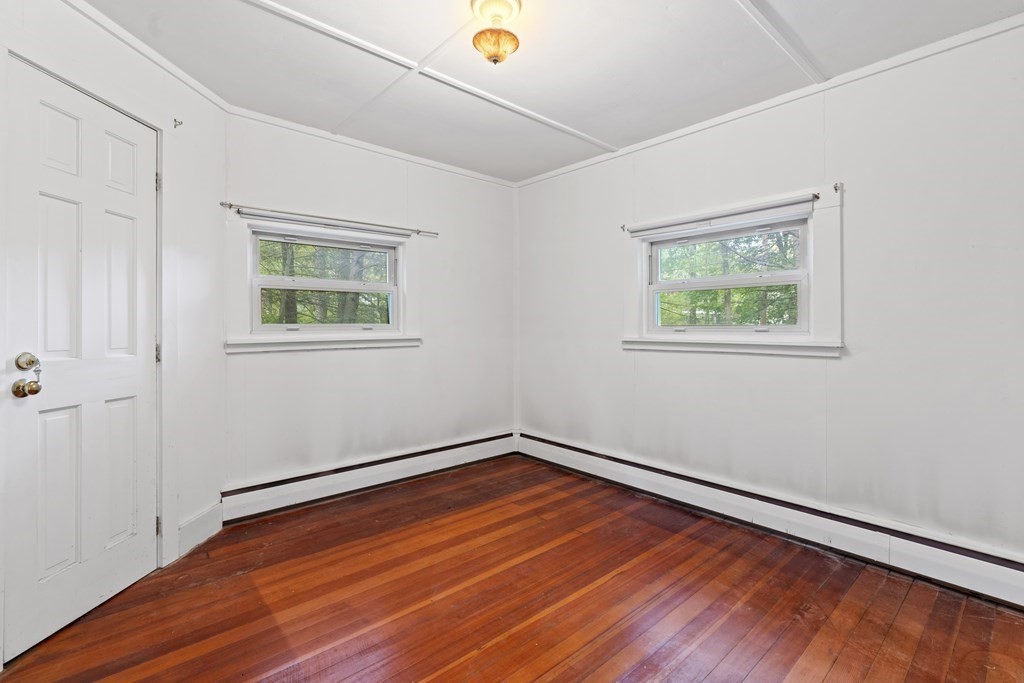 44 None Such Way Weston, MA 02493 - Photo 8 of 11 an empty room with wooden floor and windows