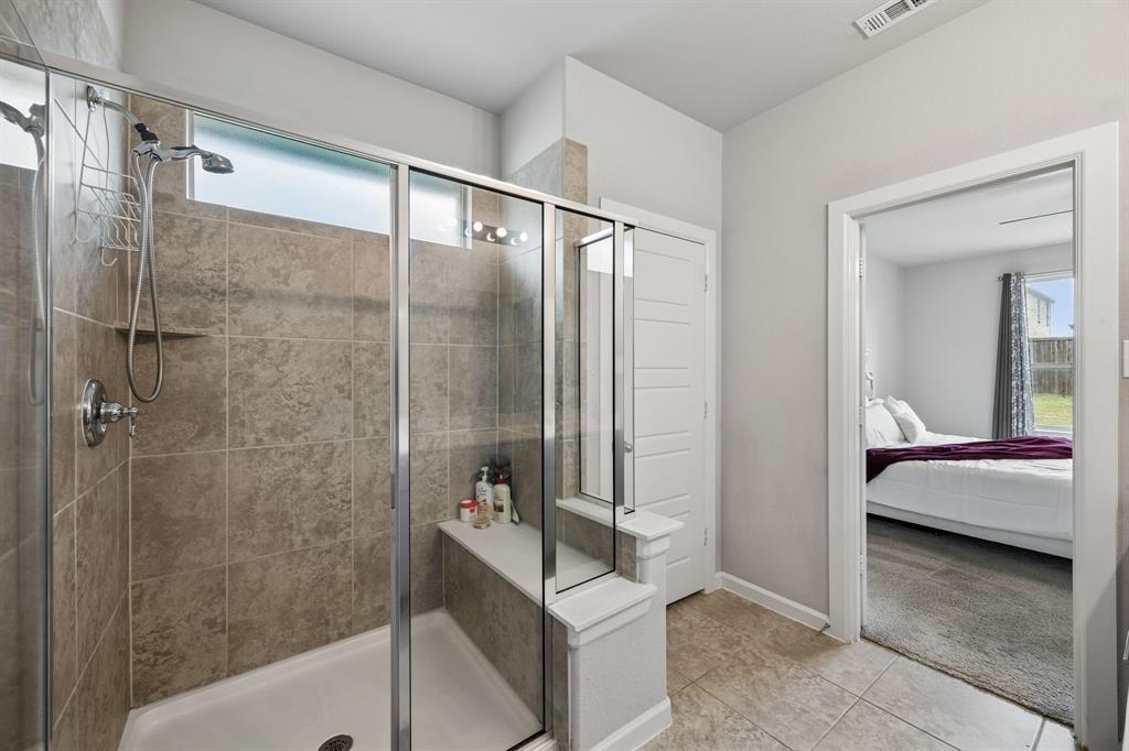 638 Hazeltine Road Red Oak, TX 75154 - Photo 20 of 29 a bathroom with a tub shower and sink