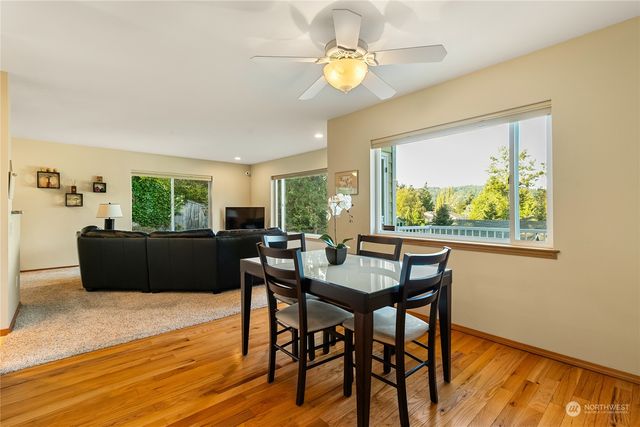 a view of a dining room with furniture a chandelier and wooden floor
