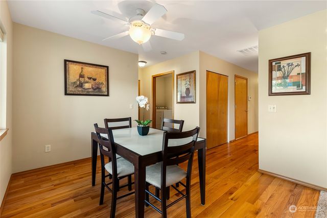 a view of a dining room with furniture and wooden floor