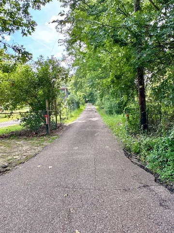 a view of a road with trees in the background