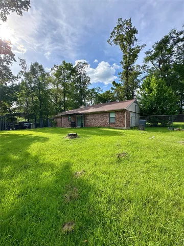 a swimming pool with outdoor seating and yard