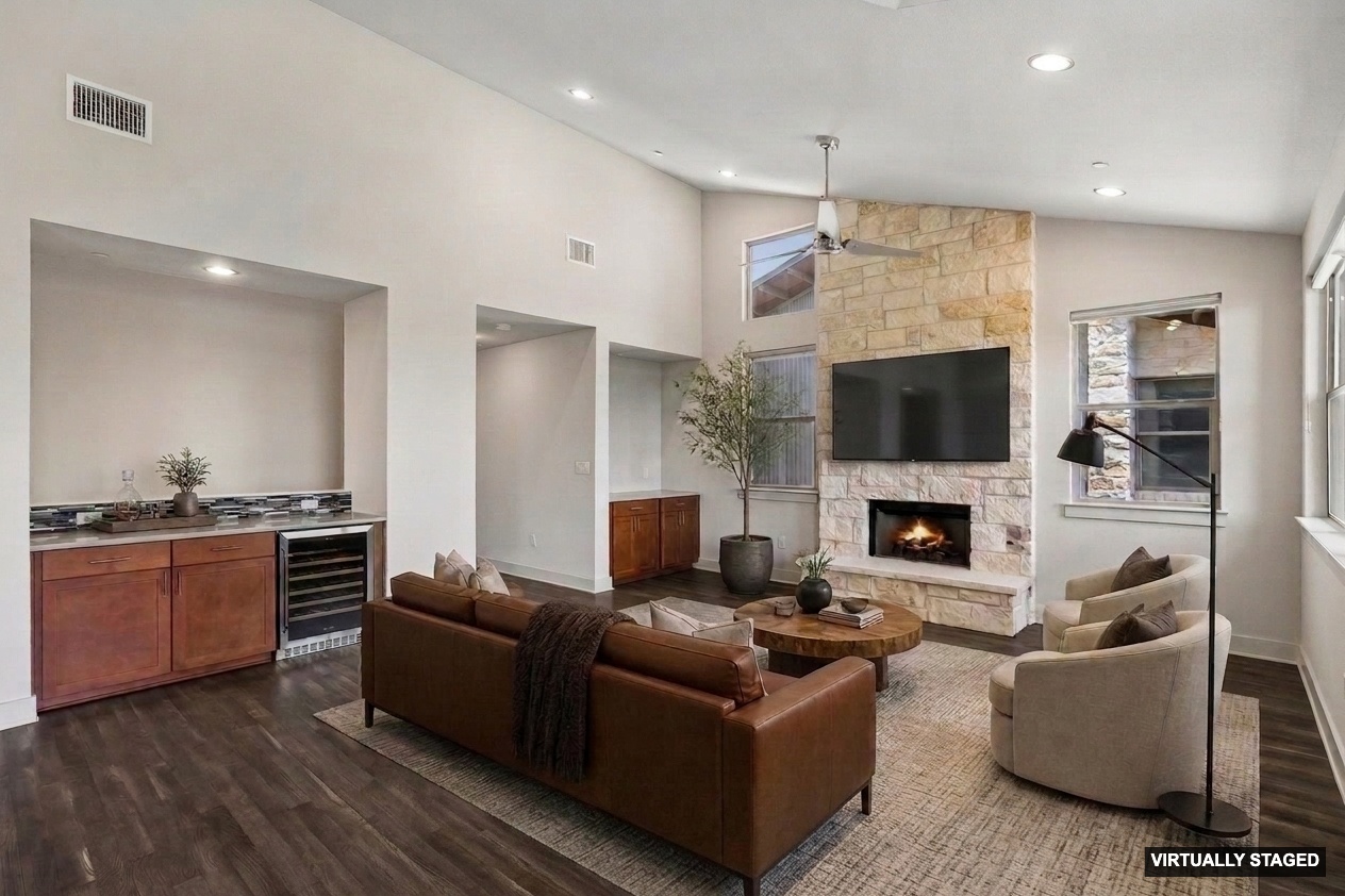 8110 Ranch Road 2222, Unit 68 Austin, TX 78730 - Photo 3 of 24 A striking stone fireplace anchors this living space, offering warmth and visual appeal.