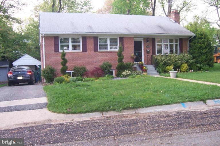 10212 Portland Road Silver Spring, MD 20901 - Photo 1 of 13 a front view of a house with a garden and yard