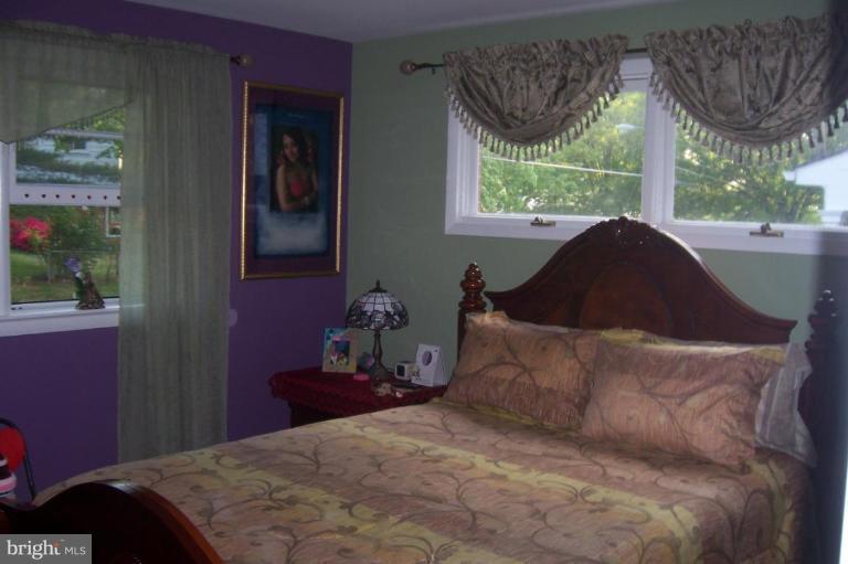 10212 Portland Road Silver Spring, MD 20901 - Photo 8 of 13 a bedroom with a bed and window