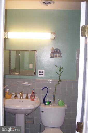 10212 Portland Road Silver Spring, MD 20901 - Photo 9 of 13 a bathroom with a sink and a mirror
