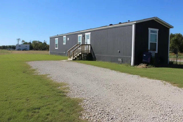 a view of a house with a yard and garage