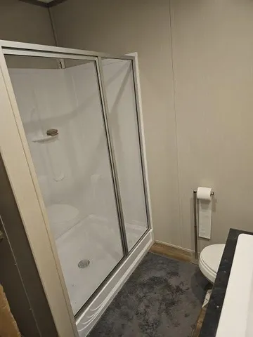 a bathroom with a shower and a toilet