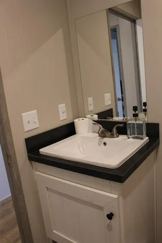 a sink sitting next to a bathroom sink