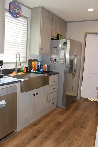 a kitchen with stainless steel appliances a refrigerator sink and cabinets