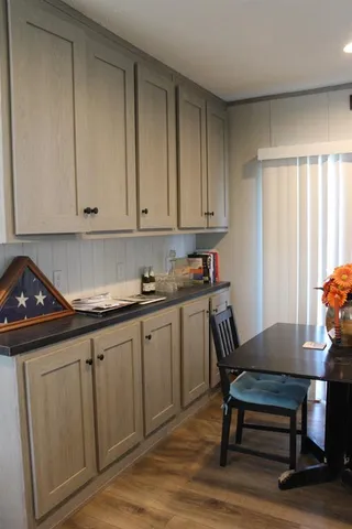 a kitchen with a sink cabinets and wooden floor