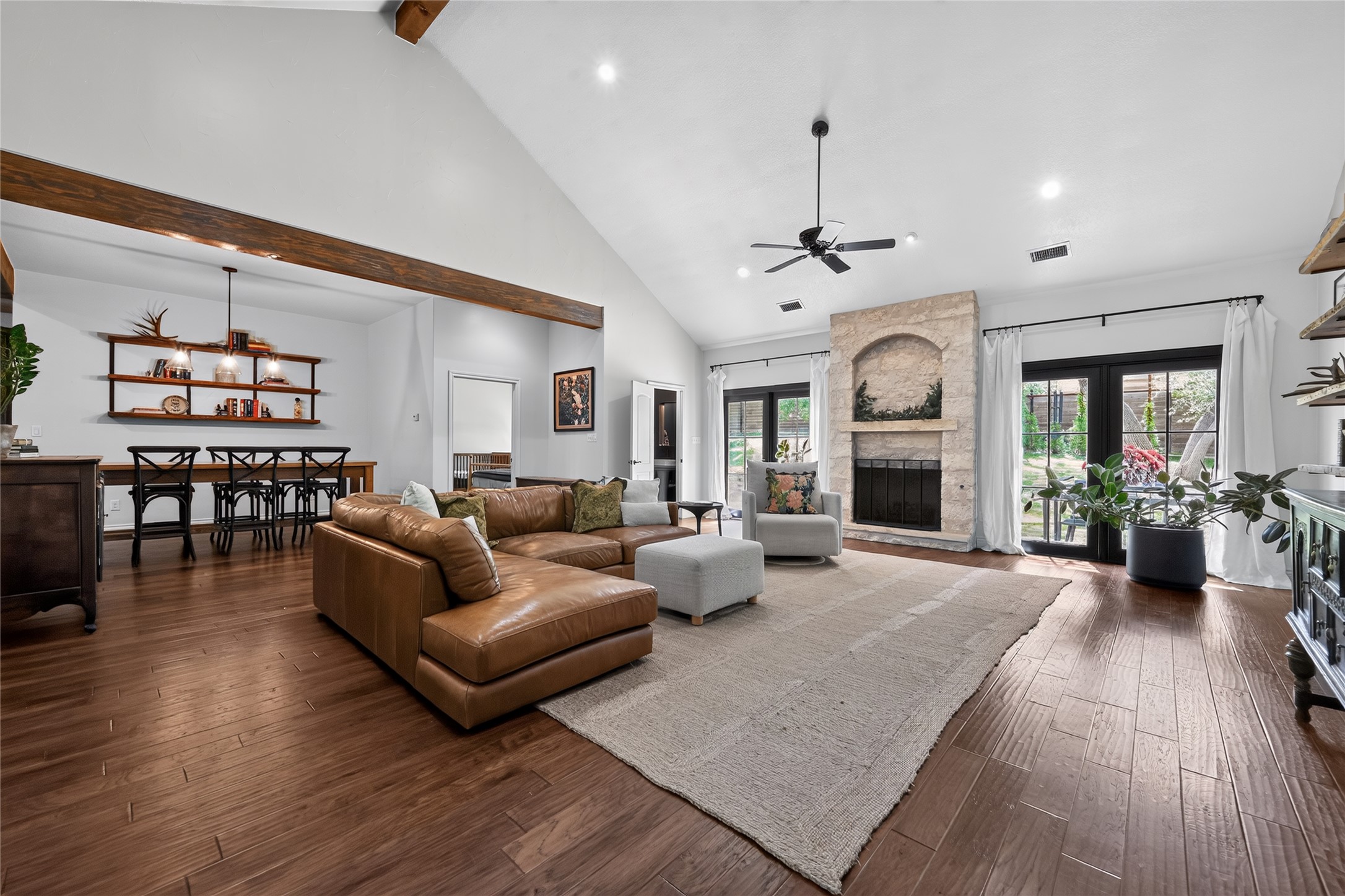 700 Willow Creek Road Salado, TX 76571 - Photo 6 of 39 Spacious living area with vaulted beamed ceilings, stone fireplace with propane logs, with an open flow to dining.
