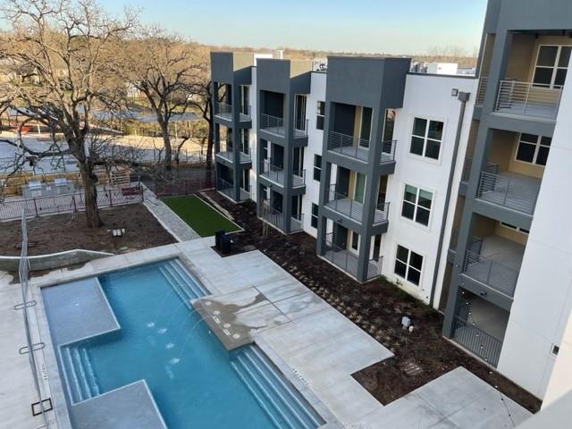 4801 Springdale Road, Unit 2211 Austin, TX 78723 - Photo 1 of 19 An inviting pool area complements the sleek, multi-story facade of this modern apartment building.