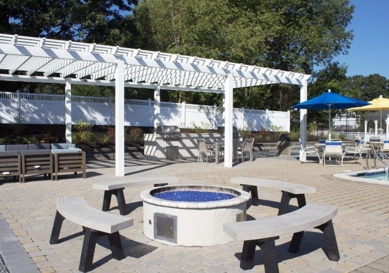 7 Queens Road Attleboro, MA 02703 - Photo 31 of 33 a view of a patio with table and chairs under an umbrella
