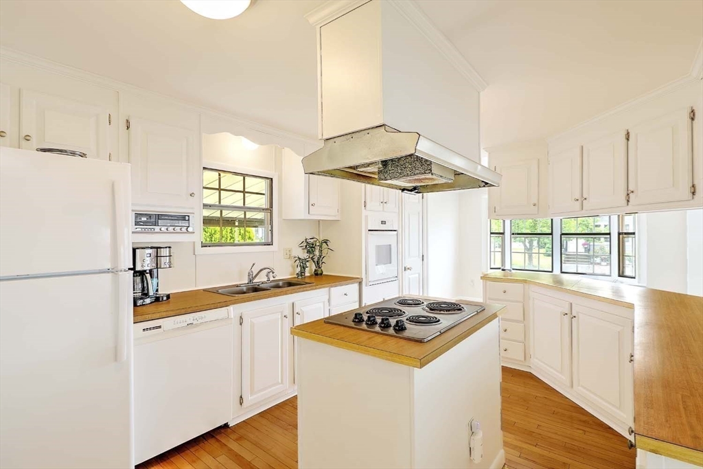 7 Queens Road Attleboro, MA 02703 - Photo 4 of 33 a kitchen with a stove a sink and a refrigerator