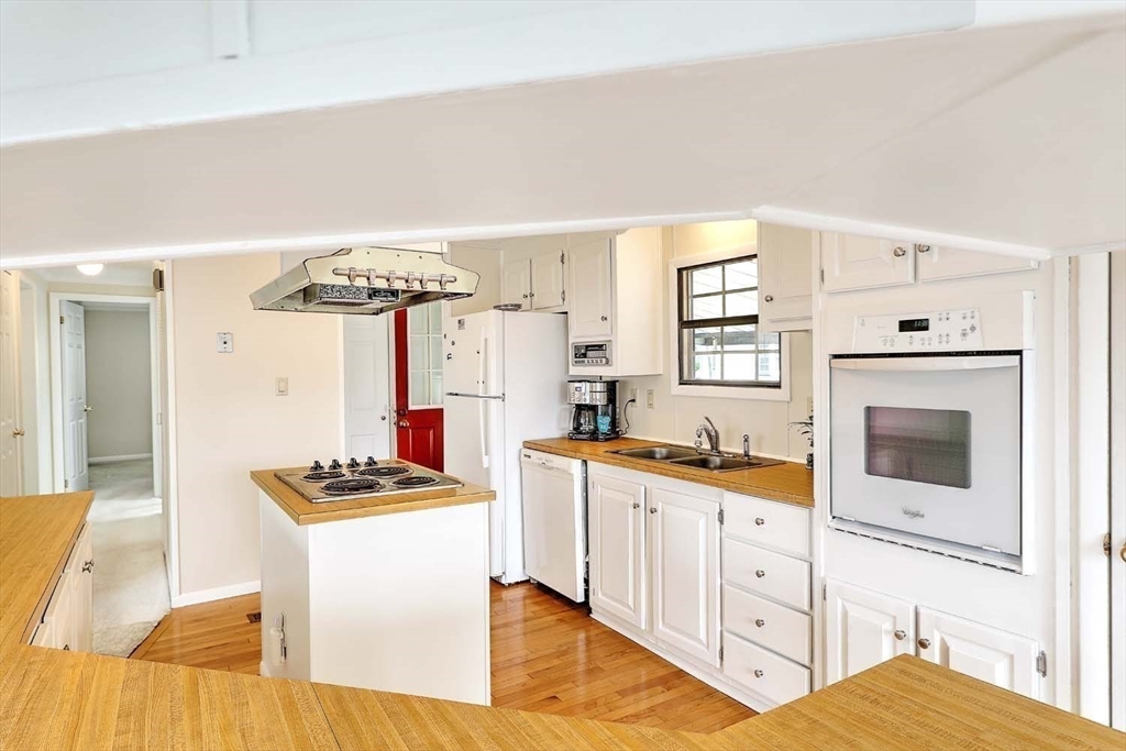 7 Queens Road Attleboro, MA 02703 - Photo 6 of 33 a kitchen with stainless steel appliances a stove a sink and a refrigerator