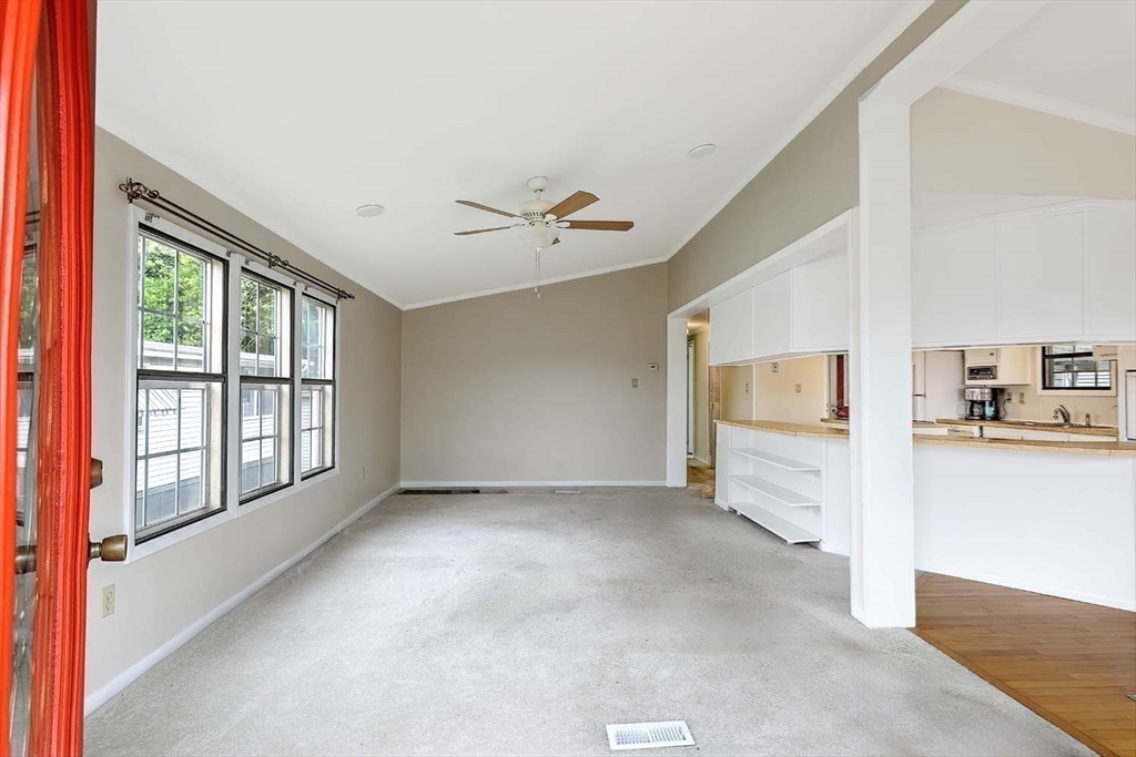 7 Queens Road Attleboro, MA 02703 - Photo 10 of 33 a view of a big room with windows and chandelier fan