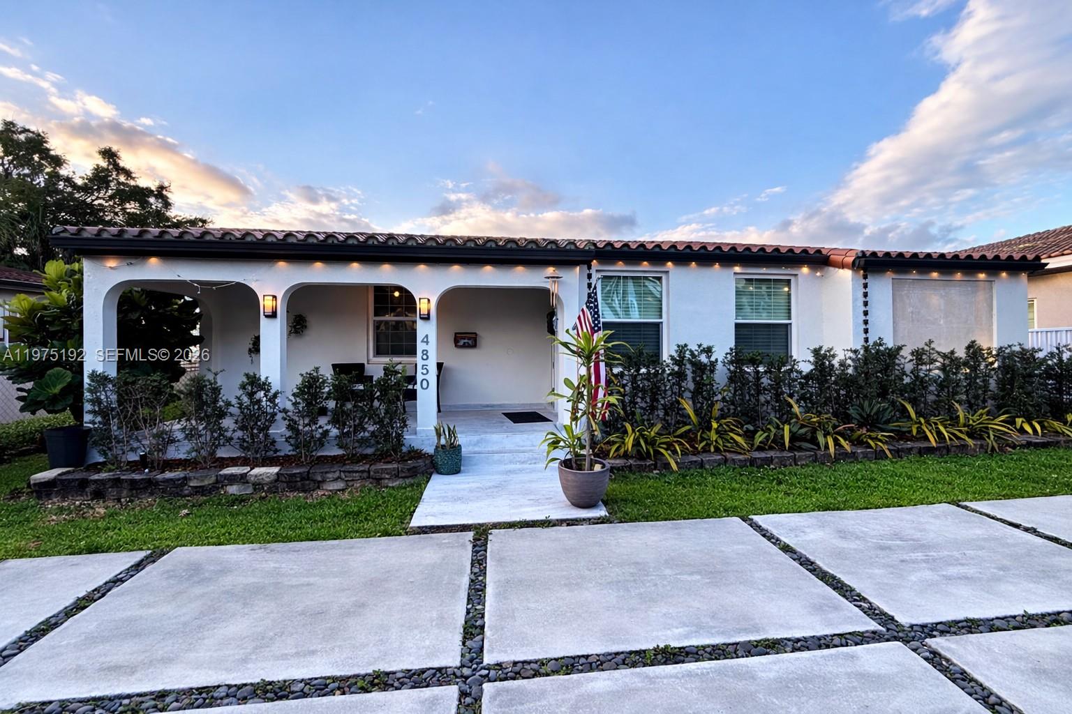 a front view of a house with garden